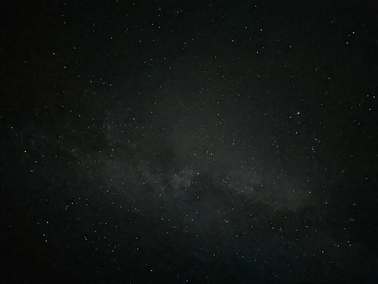 Dense star field with a faint band of the Milky Way