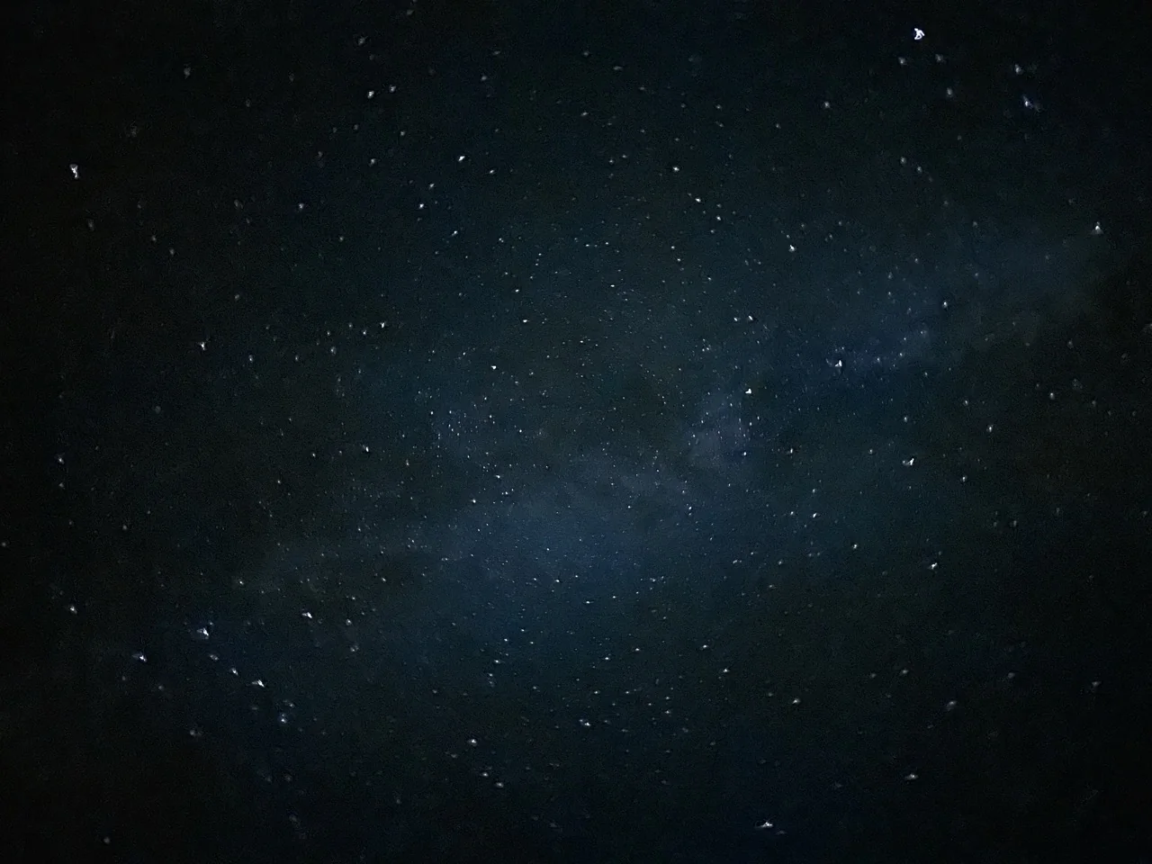 Dense stars surrounding a bluish band of the Milky Way