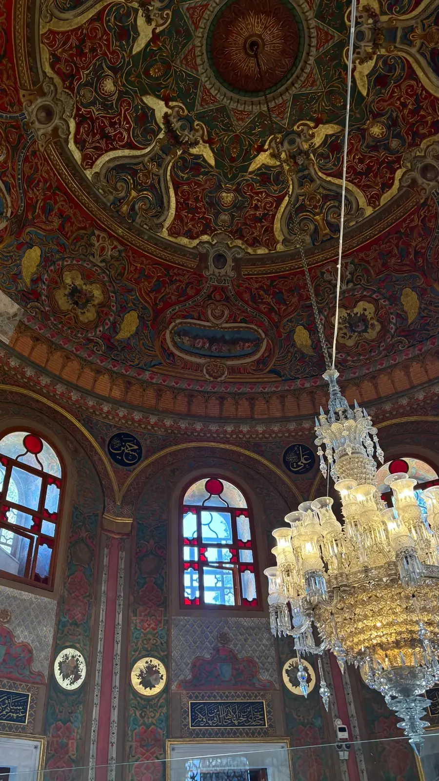 Colorful painted Ottoman interior with chandelier and decorative medallions