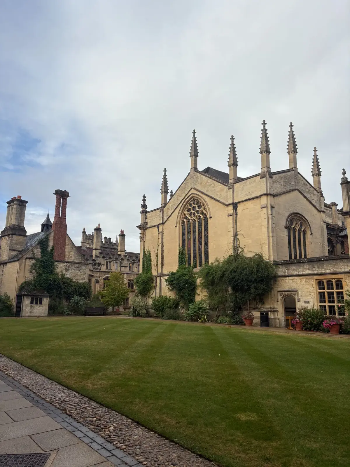 Historic Oxford college courtyard with lawn and Gothic architecture