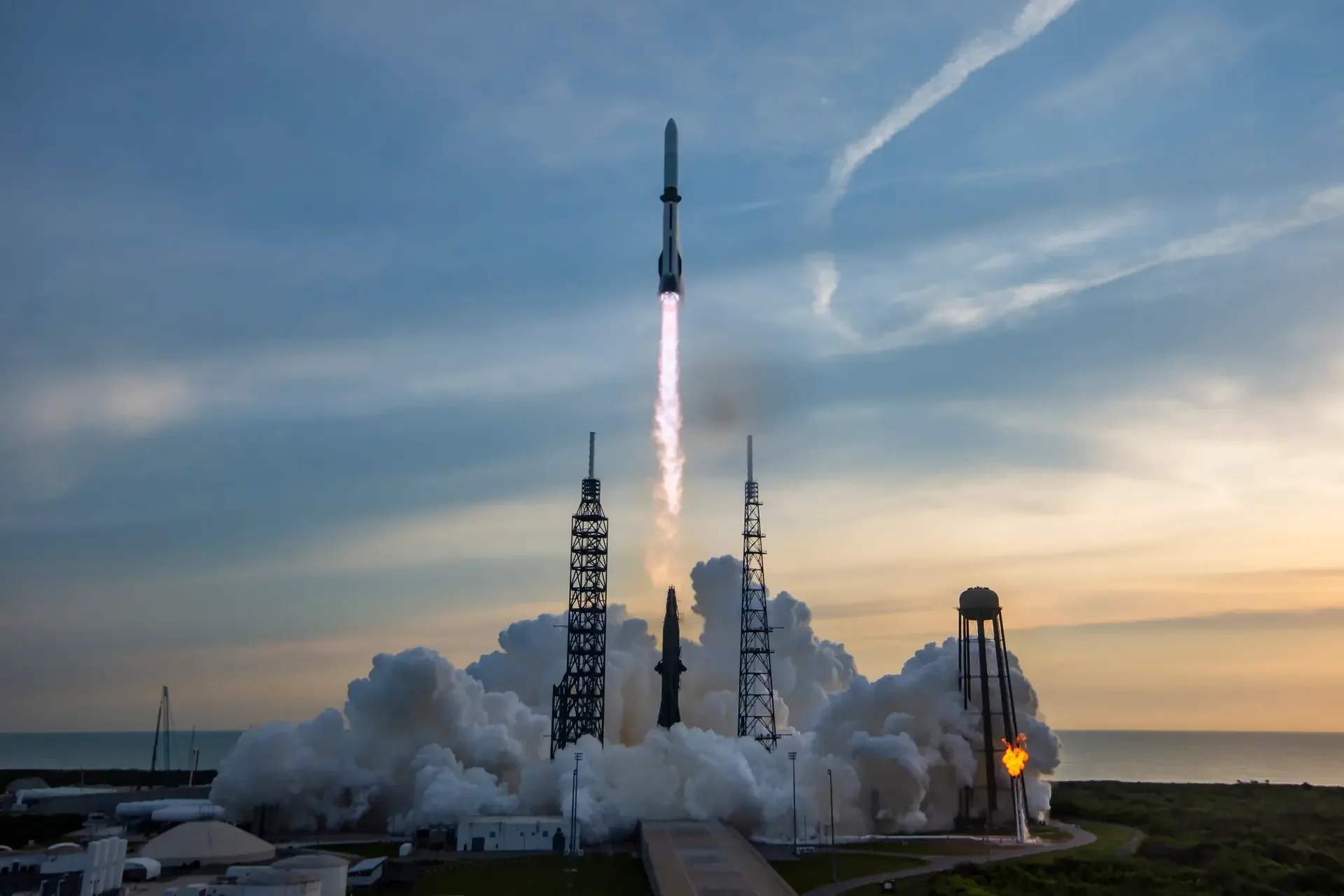 New Glenn rocket rising above the launch pad during daylight