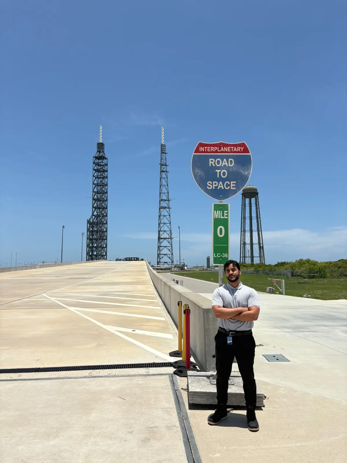 Waleed standing beside the Road to Space mile zero sign at Launch Complex 36