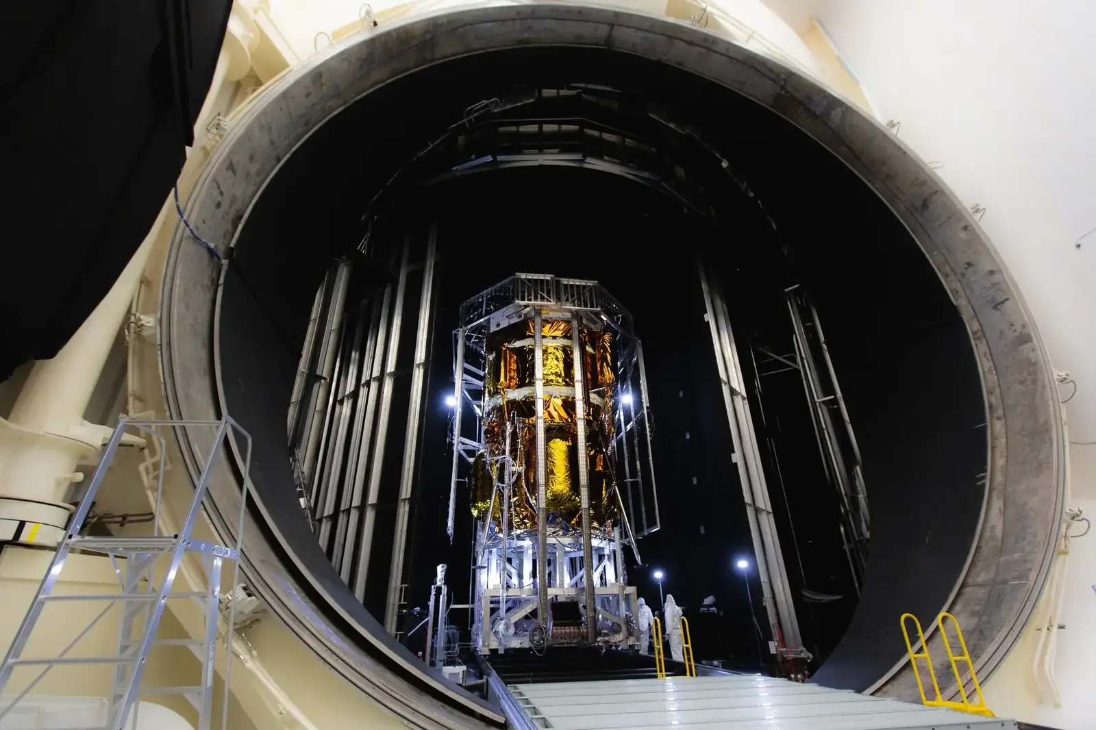 Gold-wrapped lunar spacecraft hardware positioned inside a large thermal-vacuum chamber